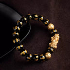 Black obsidian Pixiu Six True Words mantra wealth protection bracelet — macro stone texture | BuddhaManifest™