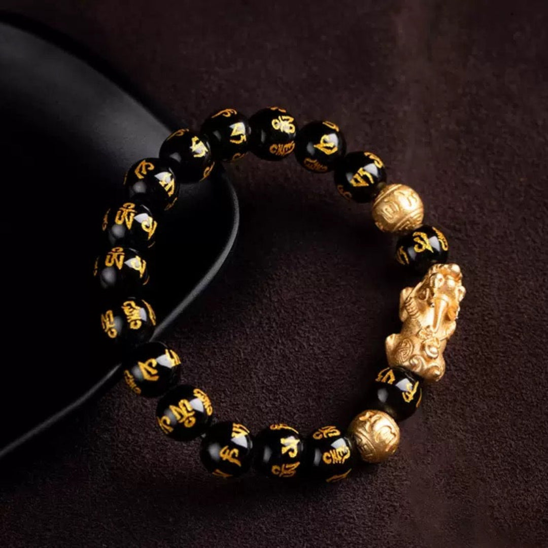 Black obsidian Pixiu Six True Words mantra wealth protection bracelet — macro stone texture | BuddhaManifest™