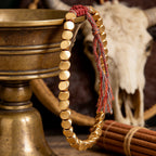 Tibetan Vajra brass red string bracelet prosperity protection handcrafted — side angle product | BuddhaManifest™