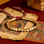 Tibetan Vajra brass red string bracelet prosperity protection handcrafted — macro stone texture | BuddhaManifest™