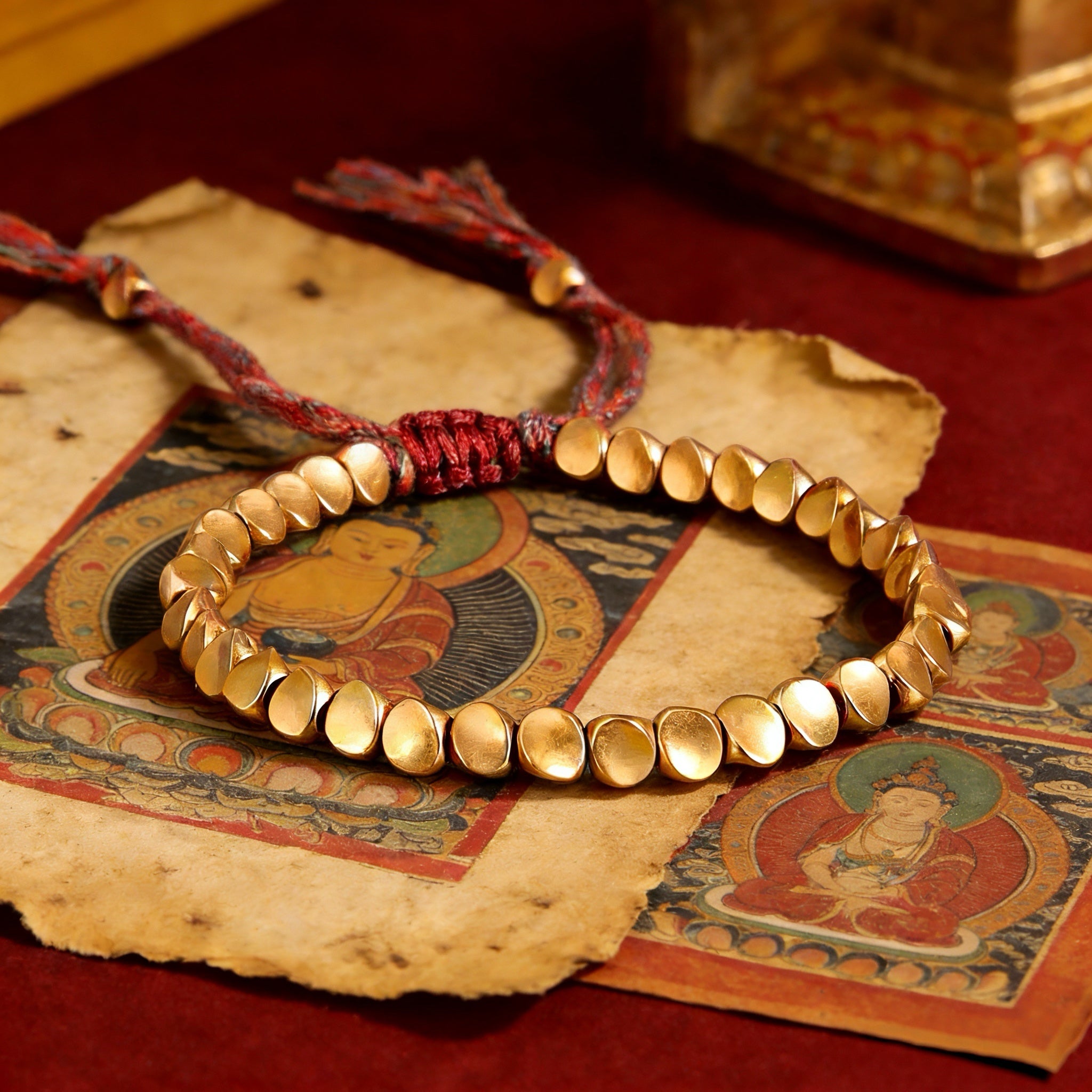 Tibetan Vajra brass red string bracelet prosperity protection handcrafted — macro stone texture | BuddhaManifest™