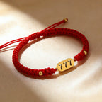 777 angel number red string bracelet alignment spiritual luck sacred cord — close-up hardware | BuddhaManifest™