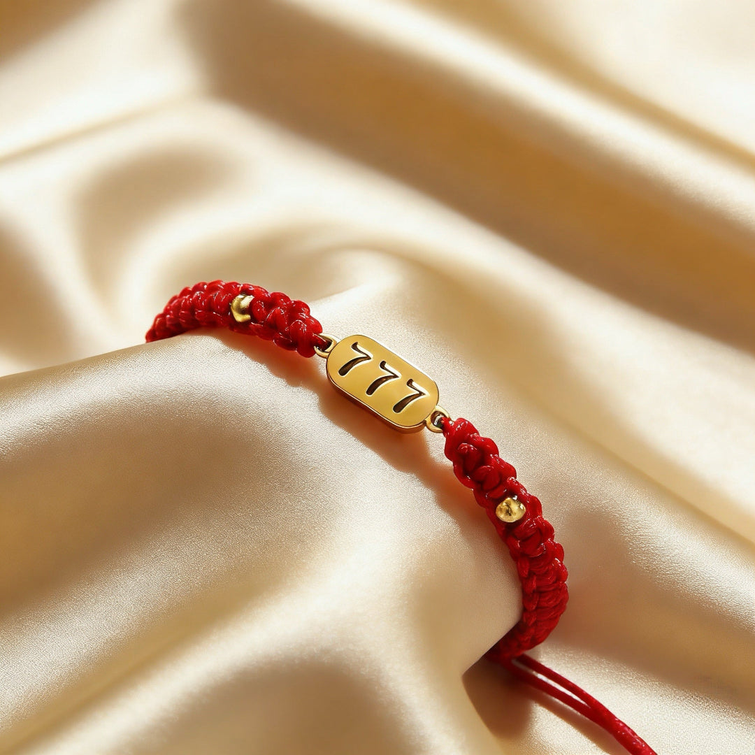 777 angel number red string bracelet alignment spiritual luck sacred cord — stack styling shot | BuddhaManifest™