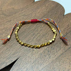 Tibetan Vajra brass red string bracelet prosperity protection handcrafted — flatlay front view | BuddhaManifest™