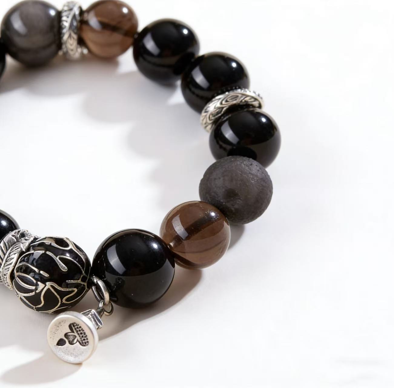 Obsidian thunder-struck wood protection bracelet grounding talisman jewelry — macro stone texture | BuddhaManifest™