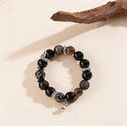 Obsidian thunder-struck wood protection bracelet grounding talisman jewelry — flatlay front view | BuddhaManifest™
