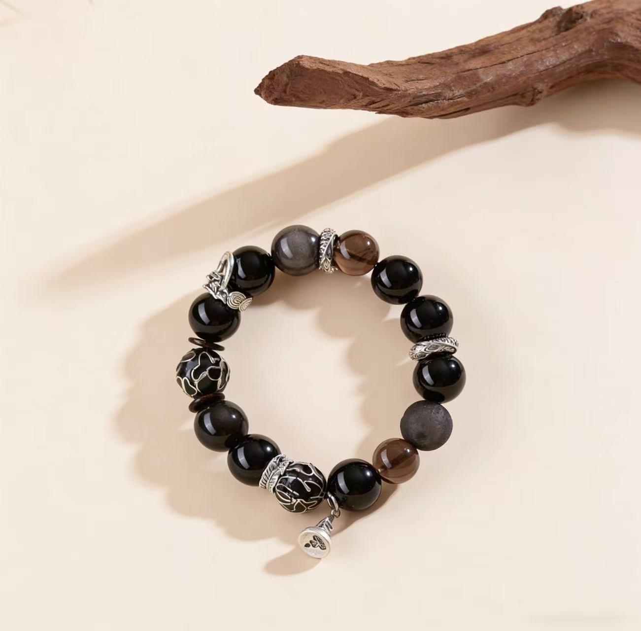 Obsidian thunder-struck wood protection bracelet grounding talisman jewelry — flatlay front view | BuddhaManifest™