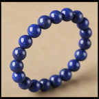Royal lapis lazuli wisdom bracelet healing crystal deep blue jewelry — bead & charm detail | BuddhaManifest™
