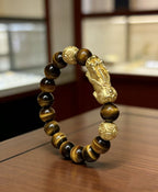 Golden tiger eye Pixiu wealth bracelet Feng Shui abundance courage jewelry — side angle product | BuddhaManifest™