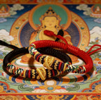 Tibetan Vajra knot red string hand-knotted protection sacred cord bracelet — macro stone texture | BuddhaManifest™