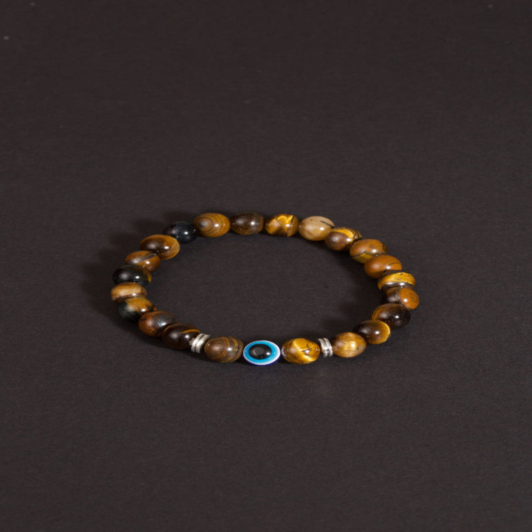 Golden tiger eye evil eye bracelet courage discernment protection — flatlay front view | BuddhaManifest™ Main image