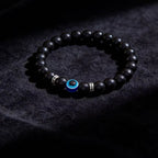 Black obsidian evil eye protection bracelet grounding boundary jewelry — side angle product | BuddhaManifest™