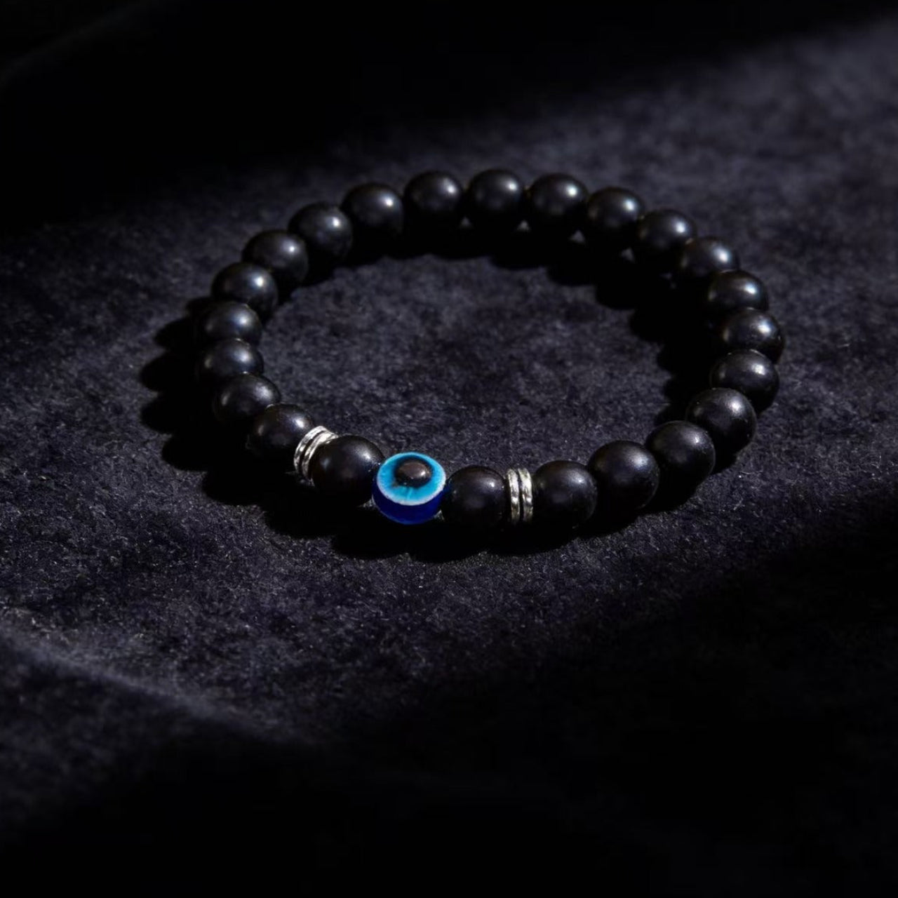 Black obsidian evil eye protection bracelet grounding boundary jewelry — side angle product | BuddhaManifest™