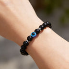 Black obsidian evil eye protection bracelet grounding boundary jewelry — bead & charm detail | BuddhaManifest™