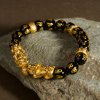 Double Pixiu obsidian Six True Words mantra wealth Feng Shui bracelet — macro stone texture | BuddhaManifest™