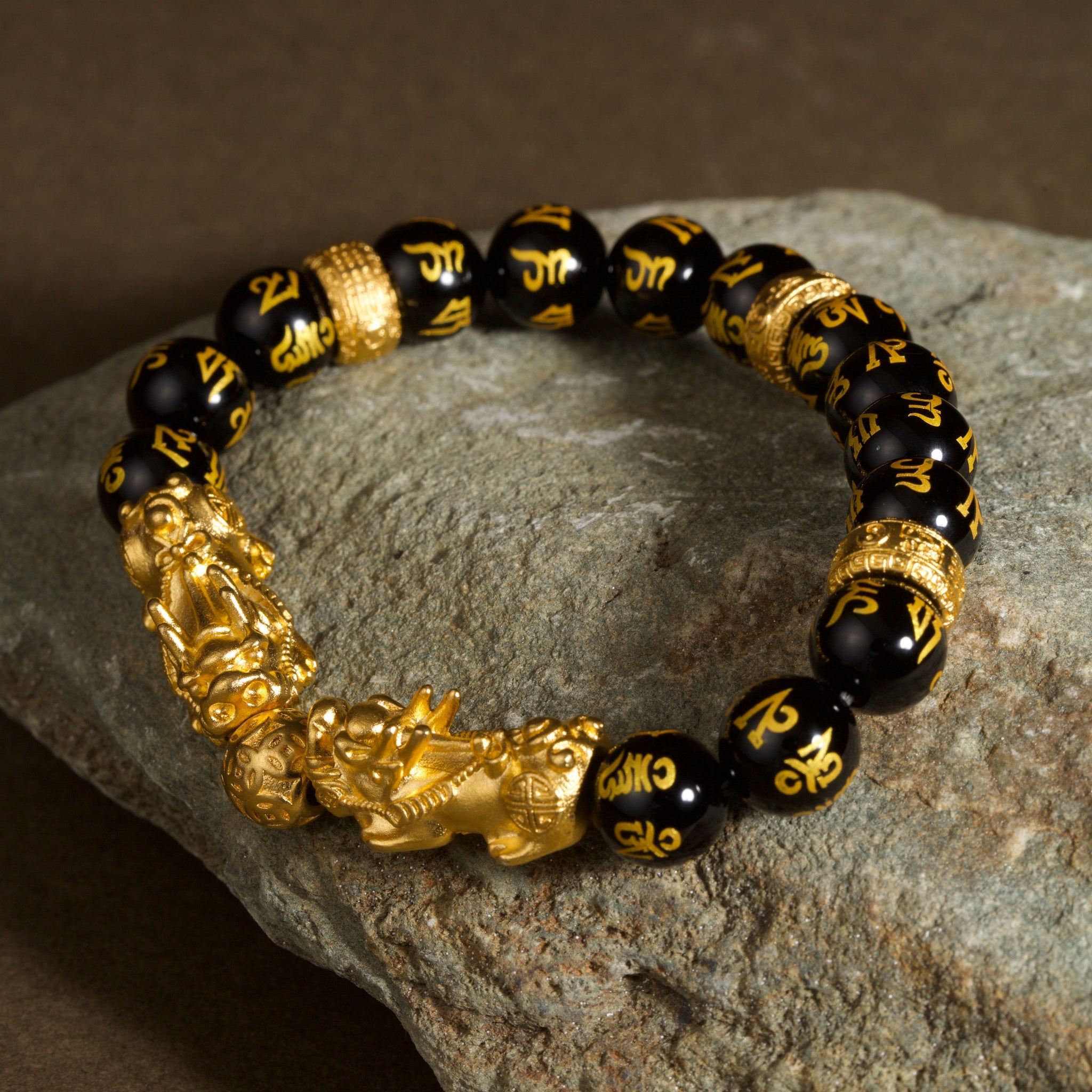 Double Pixiu obsidian Six True Words mantra wealth Feng Shui bracelet — macro stone texture | BuddhaManifest™