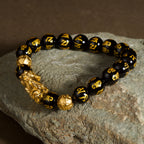 Black obsidian Pixiu Six True Words mantra wealth protection bracelet — on-wrist lifestyle | BuddhaManifest™