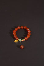 Red agate nephrite jade vitality protection stretch intention bracelet — side angle product | BuddhaManifest™