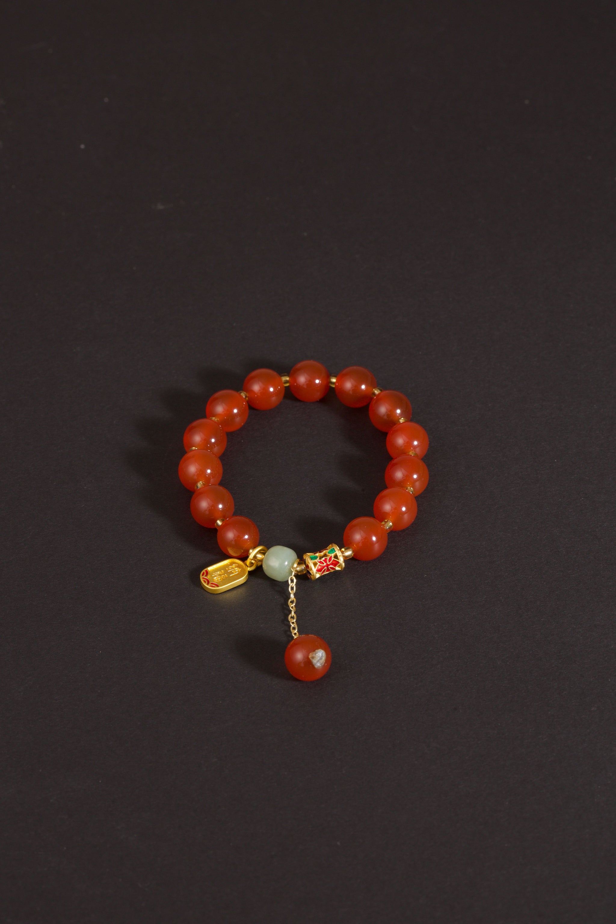 Red agate nephrite jade vitality protection stretch intention bracelet — side angle product | BuddhaManifest™