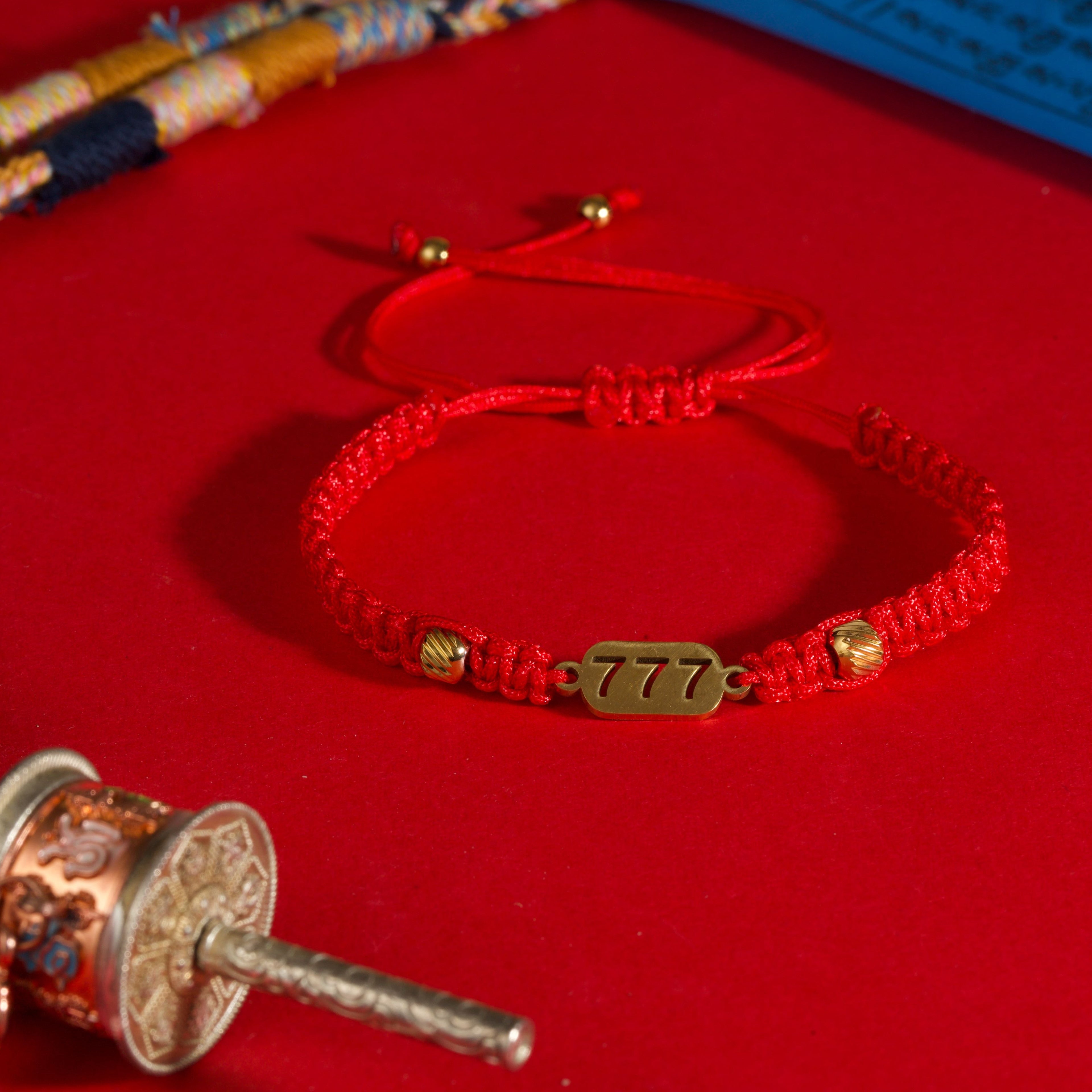 777 angel number red string bracelet alignment spiritual luck sacred cord — flatlay front view | BuddhaManifest™
