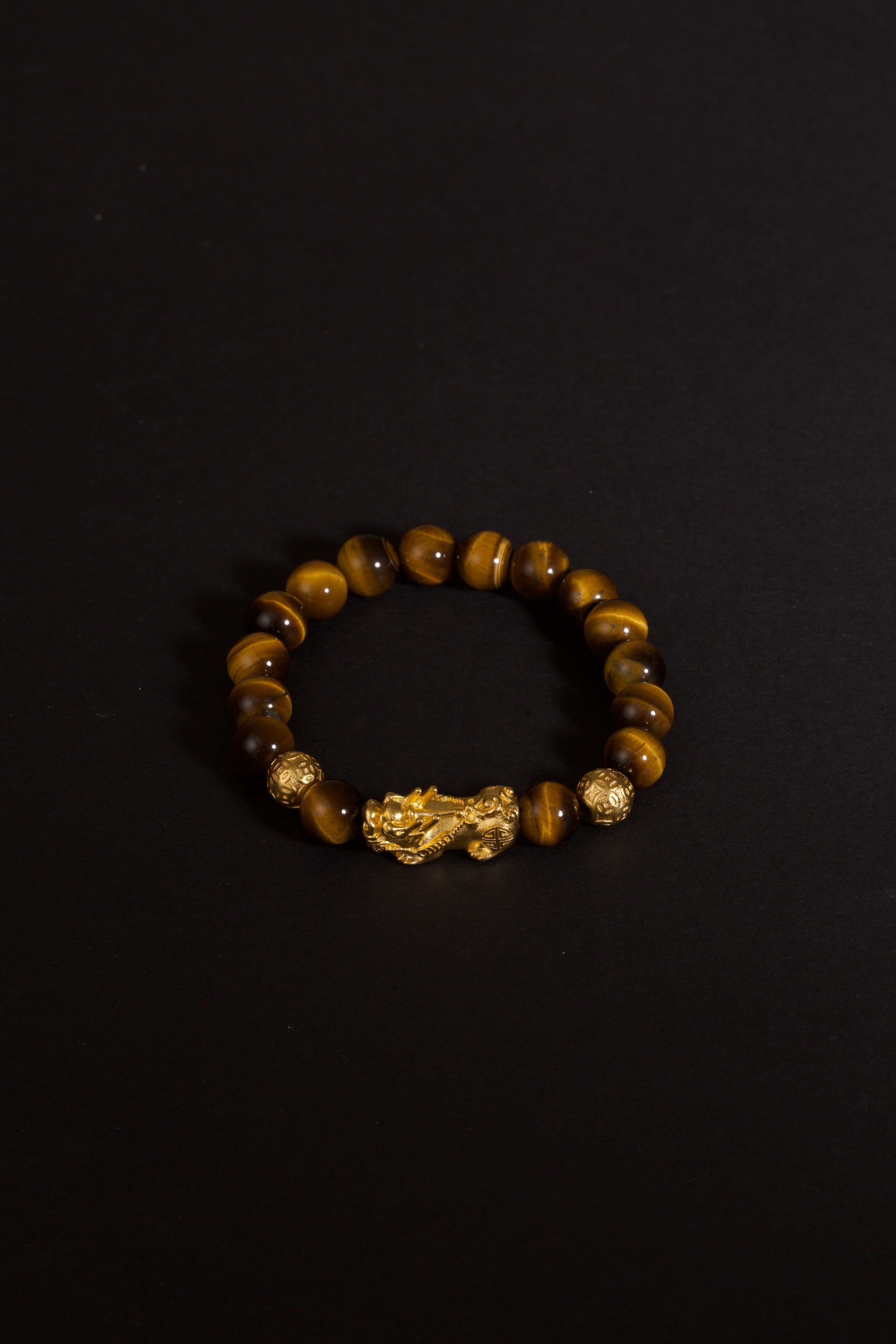 Golden tiger eye Pixiu wealth bracelet Feng Shui abundance courage jewelry — on-wrist lifestyle | BuddhaManifest™