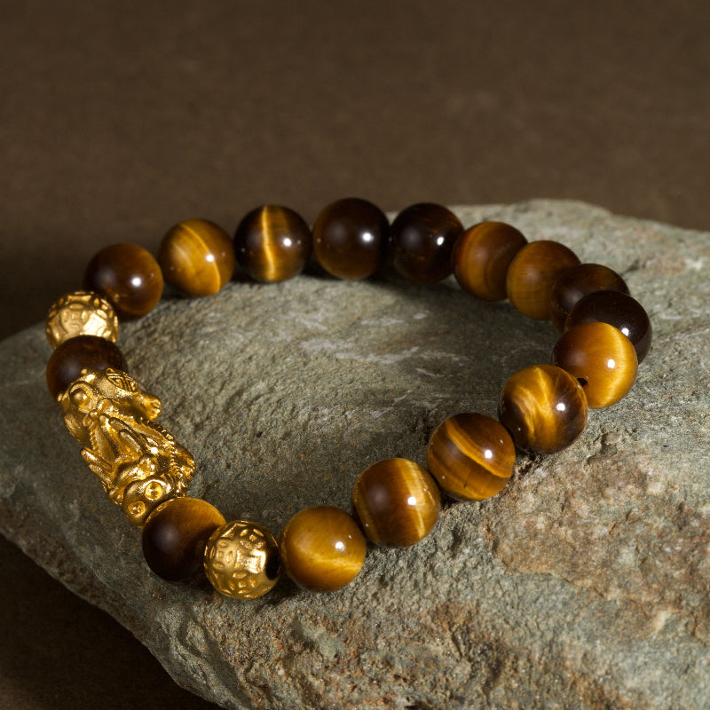 Golden tiger eye Pixiu wealth bracelet Feng Shui abundance courage jewelry — flatlay front view | BuddhaManifest™
