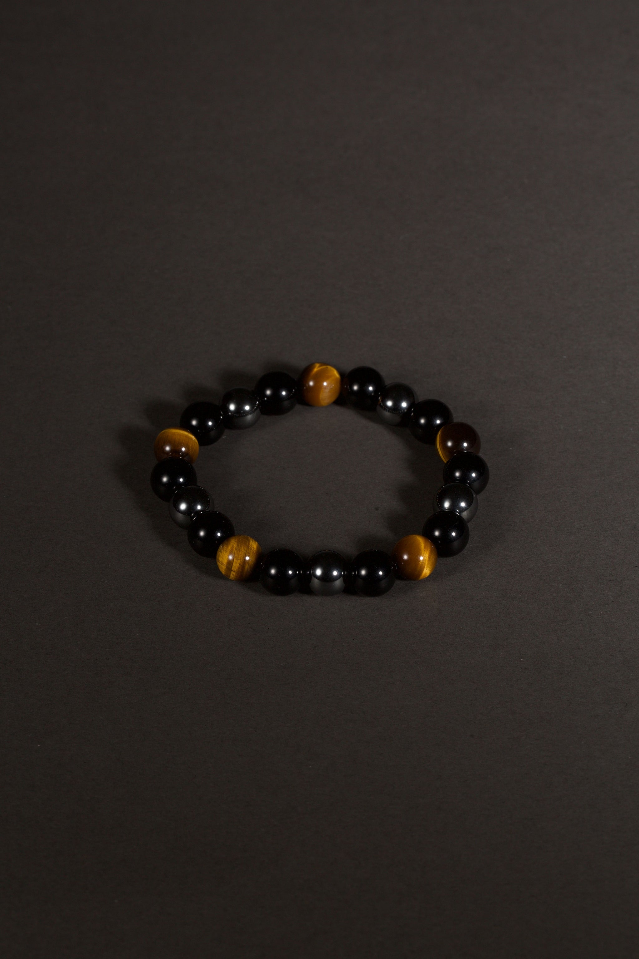 Triple protection tiger eye obsidian hematite bracelet courage shield — side angle product | BuddhaManifest™
