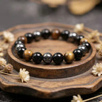Obsidian tiger eye magnetite triple protection bracelet spiritual jewelry — macro stone texture | BuddhaManifest™