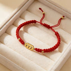 777 angel number red string bracelet alignment spiritual luck sacred cord — flatlay front view | BuddhaManifest™