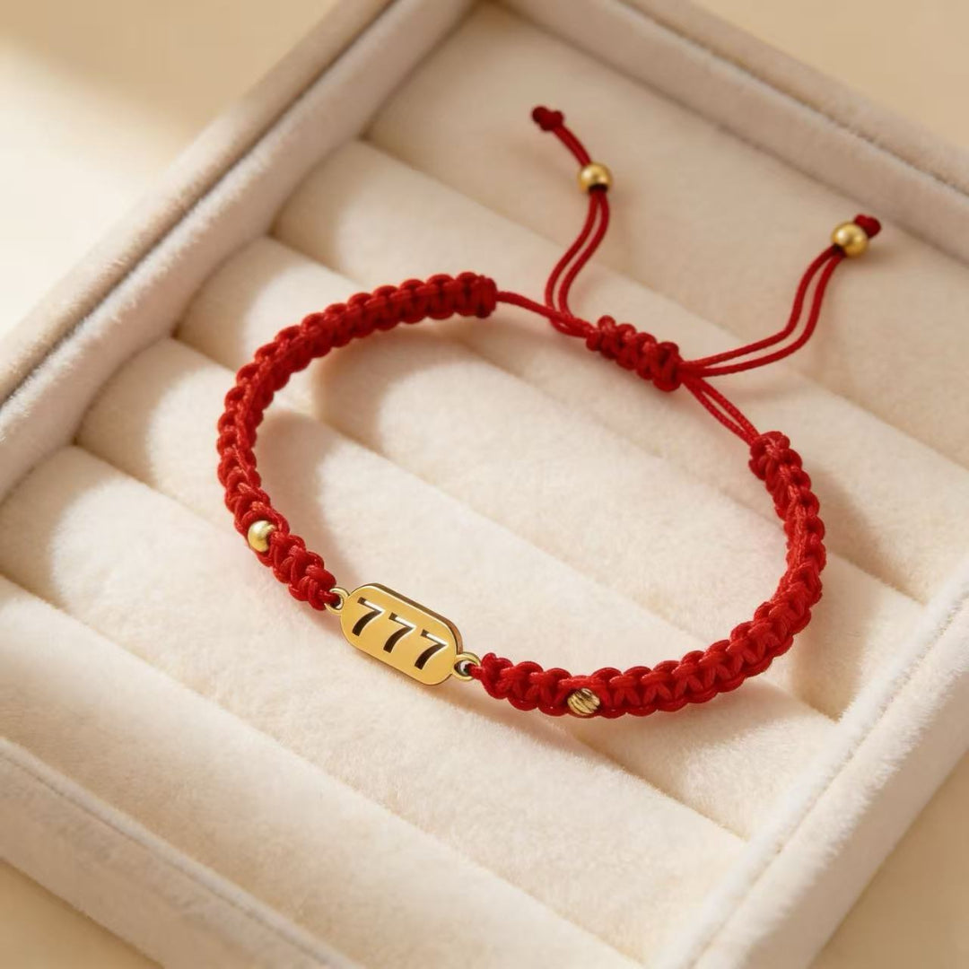 777 angel number red string bracelet alignment spiritual luck sacred cord — flatlay front view | BuddhaManifest™