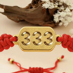 333 angel number red string bracelet support growth intention cord — macro stone texture | BuddhaManifest™