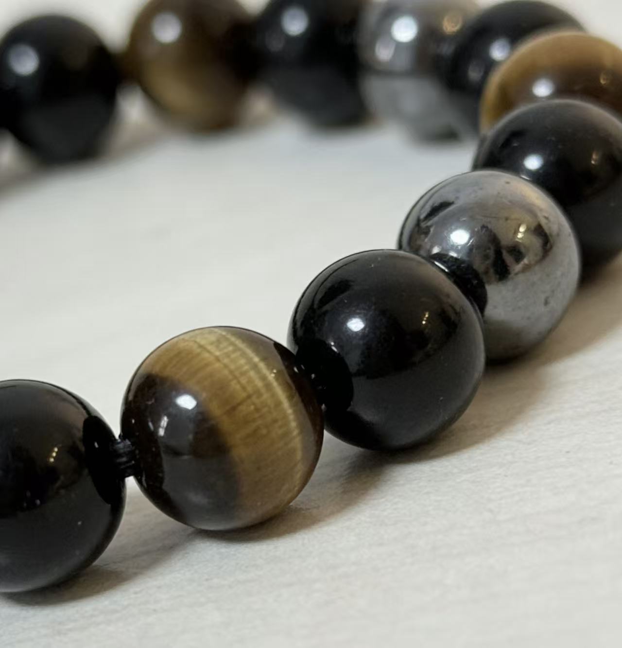 Triple protection tiger eye obsidian hematite bracelet courage shield — stack styling shot | BuddhaManifest™