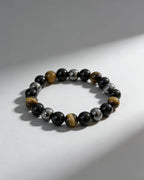 Triple protection tiger eye obsidian hematite bracelet courage shield — flatlay front view | BuddhaManifest™