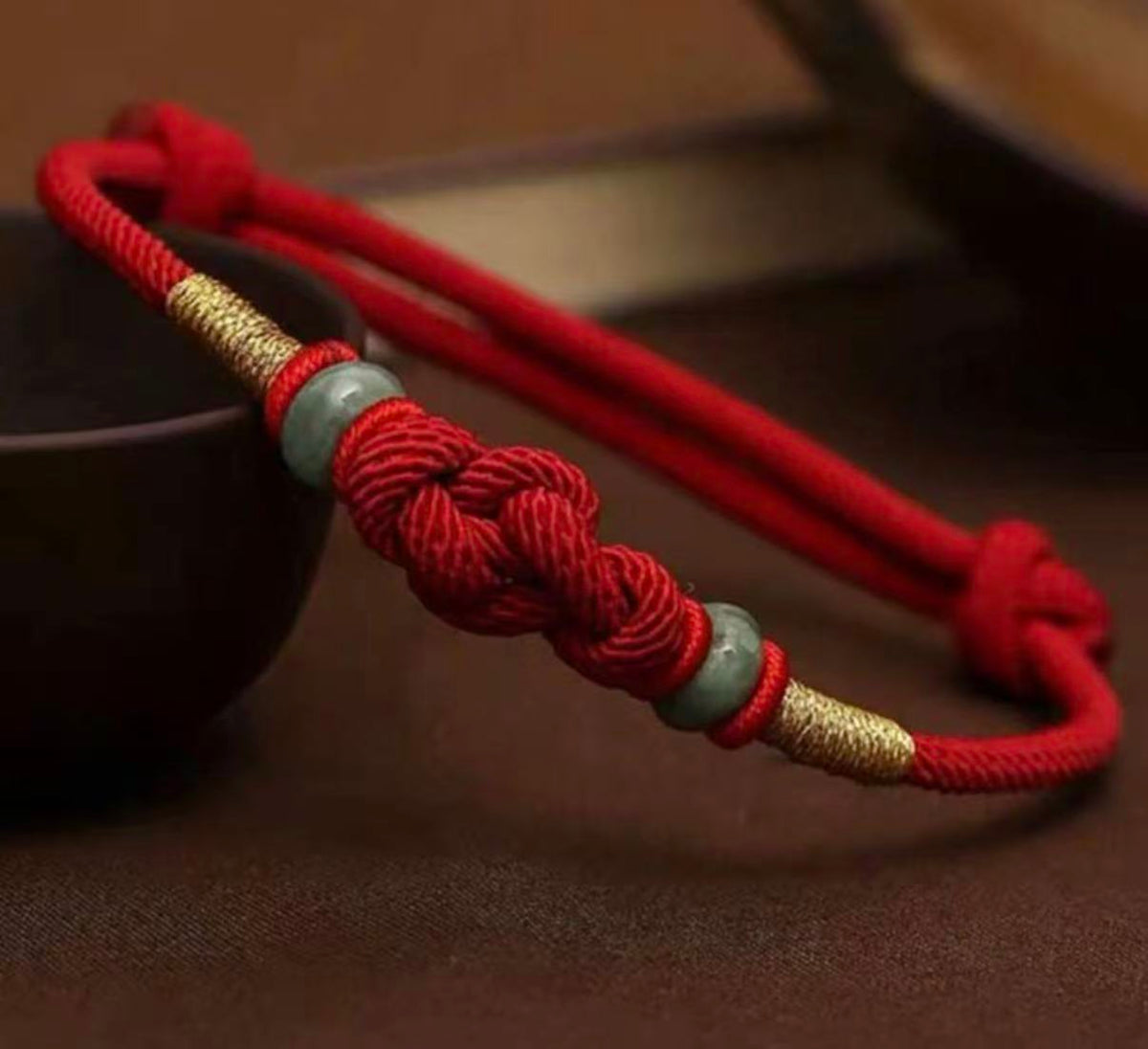 Vajra knot red string bracelet hand-knotted Tibetan protection cord — flatlay front view | BuddhaManifest™ Main image