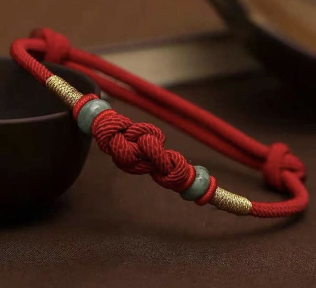 Vajra knot red string bracelet hand-knotted Tibetan protection cord — flatlay front view | BuddhaManifest™ Main image